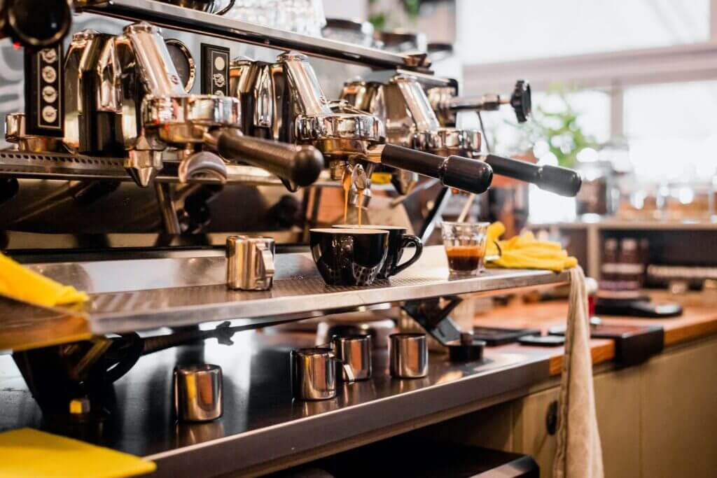 stainless steel espresso machine on brown wooden table